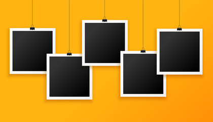 five hanging photo frames on yellow background