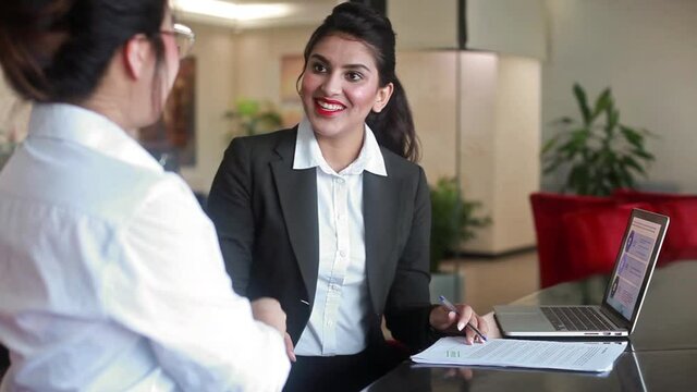 Indian banker getting documents signed from the client