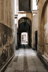 Fototapeta na wymiar motley narrow street arch in europe