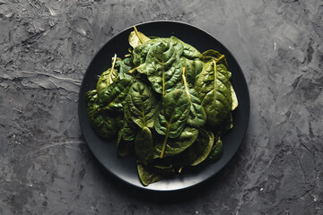 Vegetarian green spinach, leaves of spinach in dark deep colors, Vegan, wholesome foods.