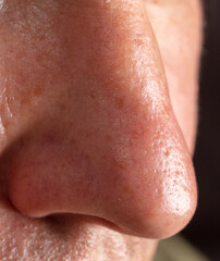 Fototapeta premium Close-up nose on the face of a man as a background.