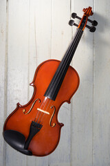 Naklejka na ściany i meble Classical violin on white table.