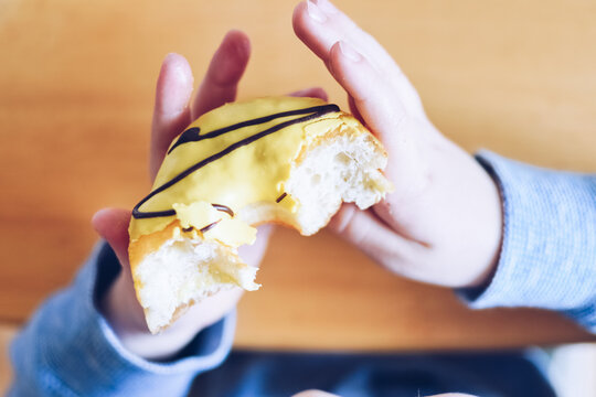 Little Boy Is Eating Donut