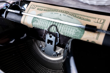 Vintage typewriter prints 10 dollar bill, make money concept