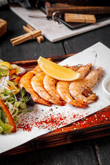 Grilled juicy shrimps with lemon greens and sauce
