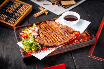 Grilled juicy steak sauce salad on wooden board