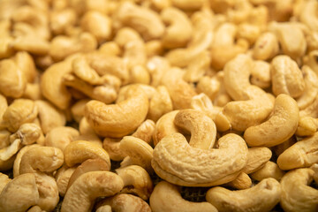 Cashew nuts scattered surface texture. Close up.