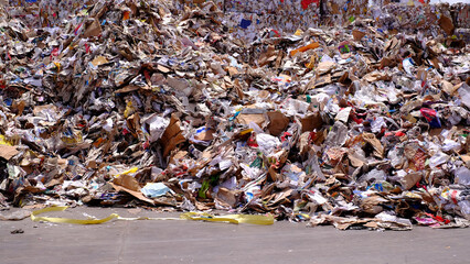 Bales of cardboard and box board. Wastepaper for Recycling. Background of paper textures piled ready to recycle on yard