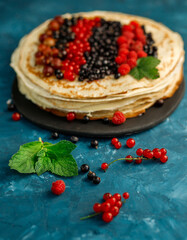 Pancakes with berries. Breakfast. Sweet homemade stack of pancakes
