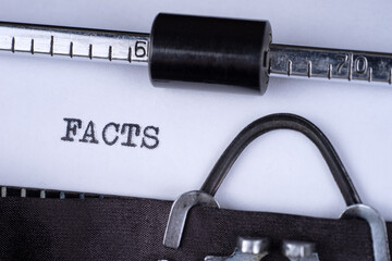The word Facts written on an old typewriter