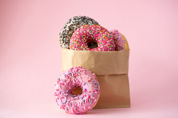 four donuts with glaze in a paper bag