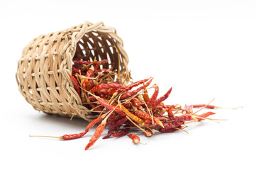 Dry chillies with dry chillies in the bowl behind blur on white background.
