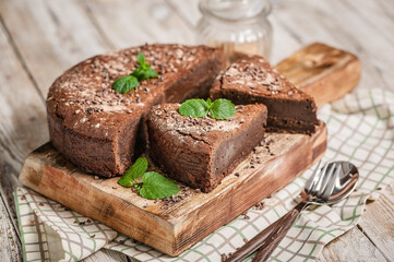 Chocolate brownie. Homemade chocolate cake on a light wooden background. Cooking delicious desserts at home. Horizontal shot