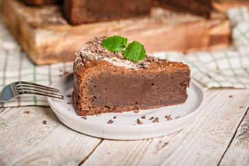 Close-up of homemade brownie chocolate cake on a plate. Cooking delicious desserts at home. Horizontal shot