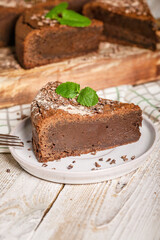 Close-up of homemade brownie chocolate cake on a plate. Cooking delicious desserts at home. Vertical shot