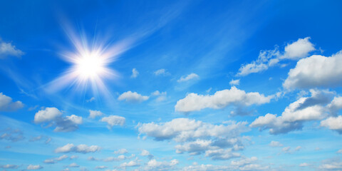 Sunny background, blue sky with white clouds and sun