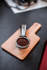 coffee powder on coffee tamper put on on cutting board