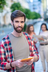 Attractive young guy with a tablet in his hands