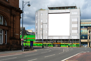 Mock up image: square blank billboard on a building. British town, Edinburgh.
