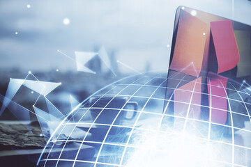 Multi exposure of table with computer and world map hologram. International data network concept.