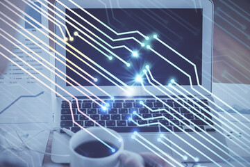 Double exposure of laptop computer and technology theme hologram. Concept of freelance work.