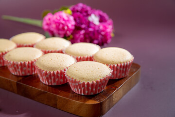 Ancient egg cakes in paper cup with purple background