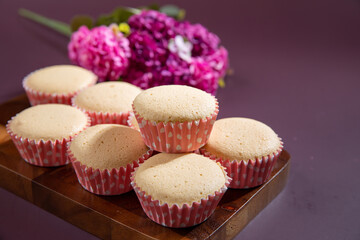 Ancient egg cakes in paper cup with purple background