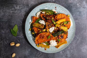 Roast butternut squash and courgettes with feta and yougurt sauce