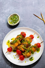 Spicy salmon skewers with parsley oil