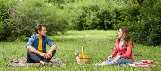 Couple have date during the coronavirus lockdown crisis. Man and woman in the park. Social distancing and virus protection.