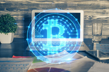 Multi exposure of blockchain theme hologram and table with computer background. Concept of bitcoin...