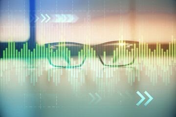 Financial graph hologram with glasses on the table background. Concept of business. Double exposure.