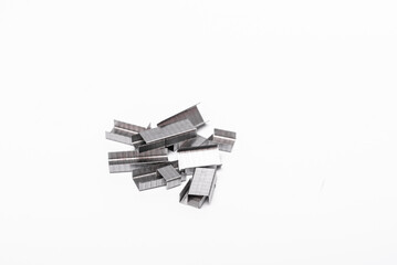 a pile of staple inserts insulated on a white surface
