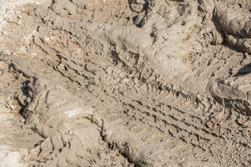 Wheel track on road muddy. Mud texture background.