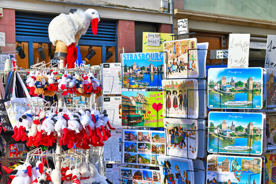 Strasbourg, France -  Racks with Alsace region souvenirs like postcards or plush storks