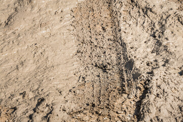 Wheel track on road muddy. Mud texture background.