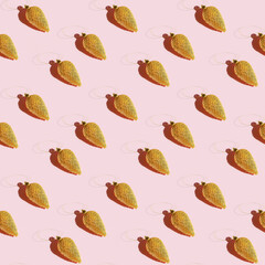 Seamless regular creative pattern with bump Christmas golden toy with dark shadow on pink paper. Printing on fabric, wrapping paper.