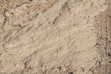 Wheel track on road muddy. Mud texture background.