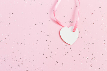 Holiday background with small white heart. Concept for Valentines day, Birthday. Top view. Minimal...