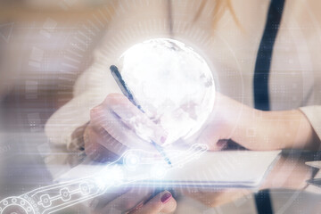 Multi exposure of hands making notes with world map hologram and data theme icons. Concept of global data.
