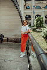 African woman glasses and modern clothes combination posing in modern city