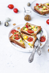 Ham and fried egg open sandwich, ham and fried egg on a gray concrete table. Сlose-up, top view.