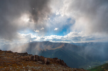 storm clouds with a gleam of blue sky high in the Altai Mountains