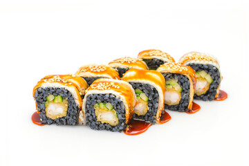 Japanese Sushi Roll with tempura shrimp, cucumber and Unagi eel on top isolated on white background. Menu isolation. Black rice roll served with sauce and sesame seeds
