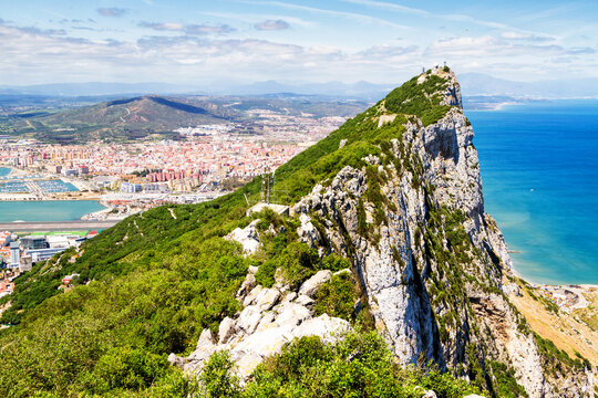 Aerial View Of Top Of Gibraltar Rock, In Upper Rock Natural Reserve: On The Left Gibraltar Town And Bay, La Linea Town In Spain At The Far End, Mediterranean Sea On The Right. United Kingdom, Europe.