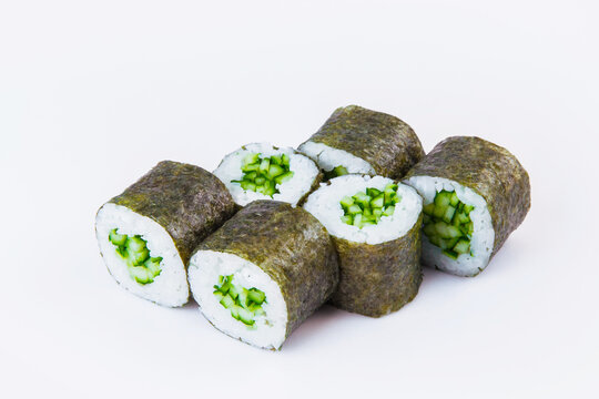 Side view of Vegetarian Japanese Maki Roll with cucumber and rice wrapped in nori seaweed. Close-up of asian traditional vegan dish isolated on gray background. Isolation menu image

