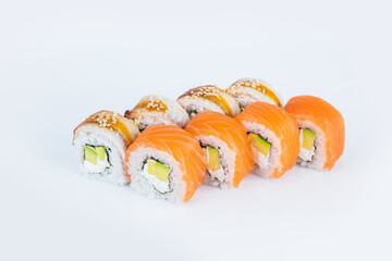 Japanese Sushi Roll with avocado, Philadelphia cream cheese with salmon and eel on top. isolated on gray background. Served with Unagi sauce and sesame seeds seeds. Asian dish Menu isolation.
