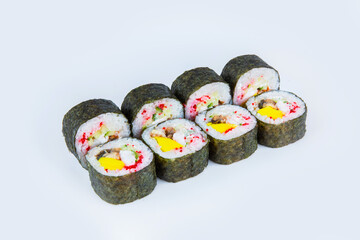 Japanese Futomaki Sushi Roll pieces isolated on gray background. Asian Maki roll with unagi eel, mango, cucumber, flying fish roe (tobiko caviar) and Philadelphia chesse. 

