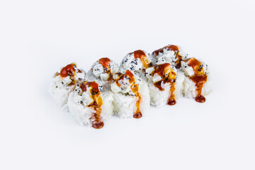Traditional Japanese Volcano Sushi Roll pieces isolated on gray background. Asian menu dish with scallop, flying fish roe (Tobiko caviar) served with Unagi sauce, isolation on gray
