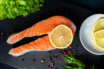 red fish steak with herbs, spices and lemon